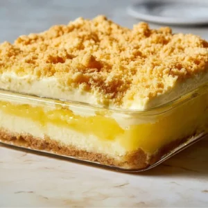 Delicious Lemon Cream Cheese Dump Cake served on a plate with a slice cut out.